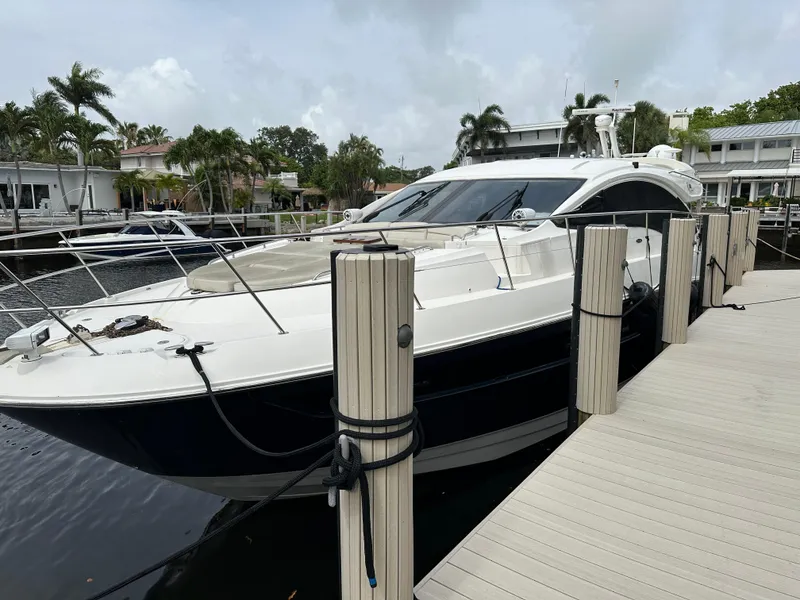 The Image of 2016 Sea Ray L590 yacht docked at marina with palm trees in background. - 0