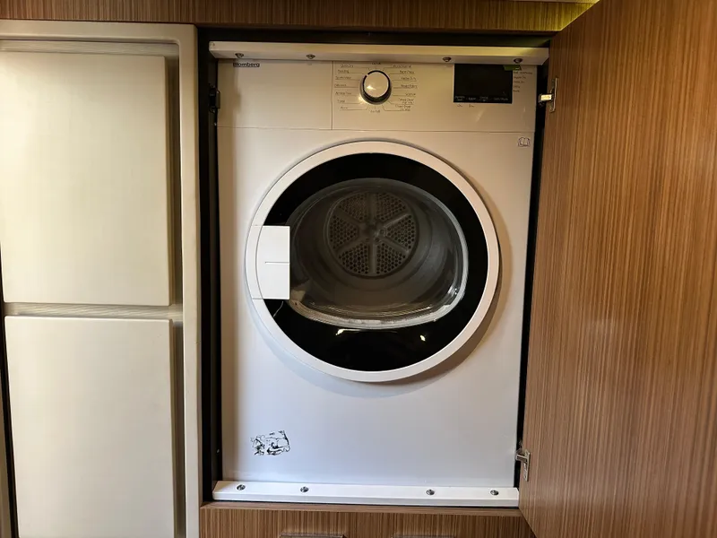 Slide: The Image of Blomberg dryer installed in 2016 Sea Ray L590 yacht's wooden cabinet. - 11