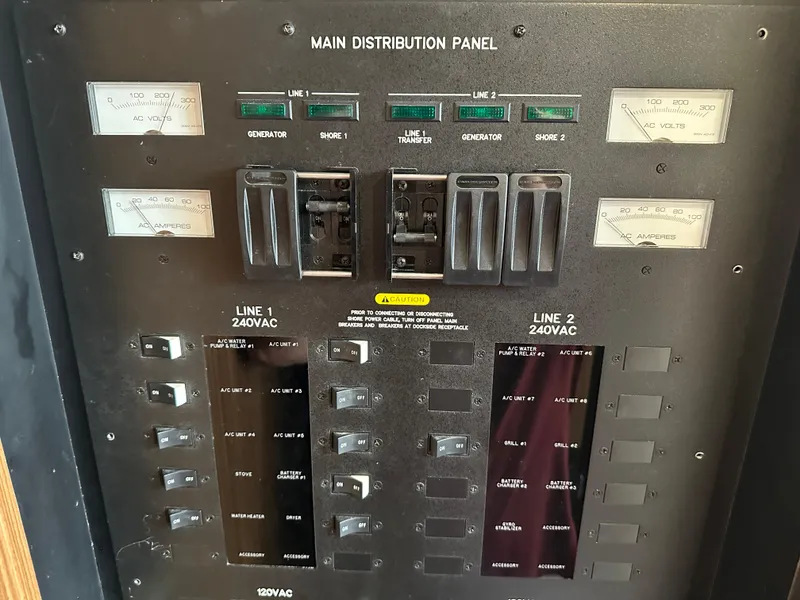 Slide: The Image of Main distribution panel of 2016 Sea Ray L590 yacht, showing AC voltage and amperage meters. - 12