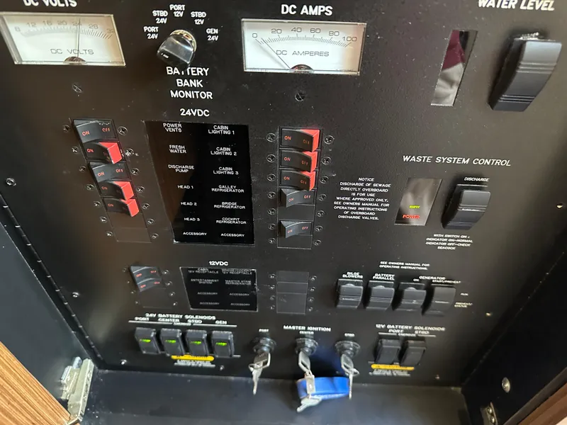 Slide: The Image of Control panel of 2016 Sea Ray L590 yacht with various switches and gauges. - 13