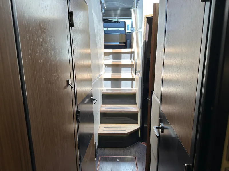 Slide: The Image of Interior view of 2016 Sea Ray L590 yacht with wooden stairs and modern design. - 18