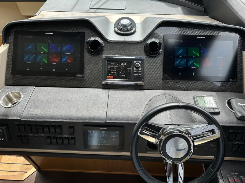 Slide: The Image of 2016 Sea Ray L590 helm with dual Raymarine displays and modern controls. - 19
