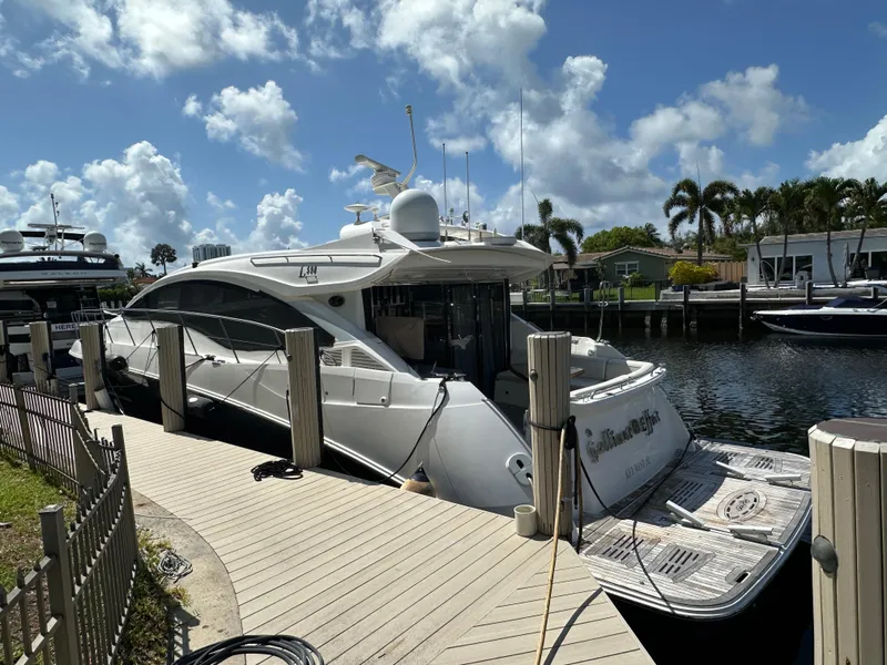 Slide: The Image of 2016 Sea Ray L590 yacht docked at marina under a clear blue sky. - 2