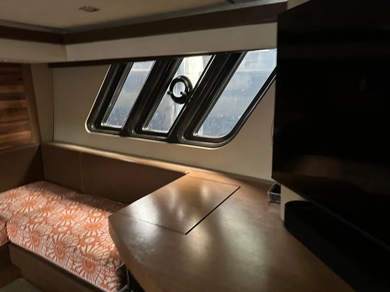 Slide: The Image of Interior of 2016 Sea Ray L590 yacht with modern seating and large windows. - 25