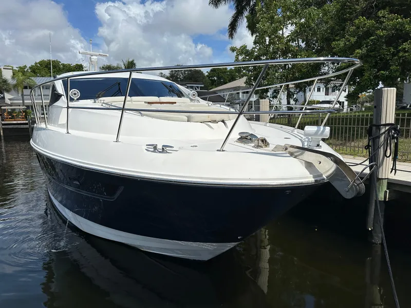 Slide: The Image of 2016 Sea Ray L590 yacht docked in a marina, featuring sleek design and luxurious amenities. - 29