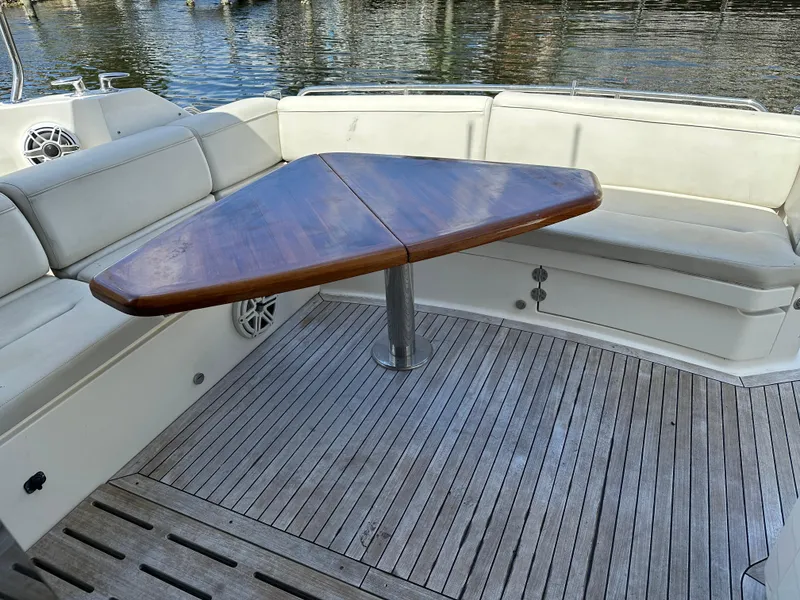 Slide: The Image of Luxurious 2016 Sea Ray L590 yacht with elegant wooden table and cushioned seating. - 31