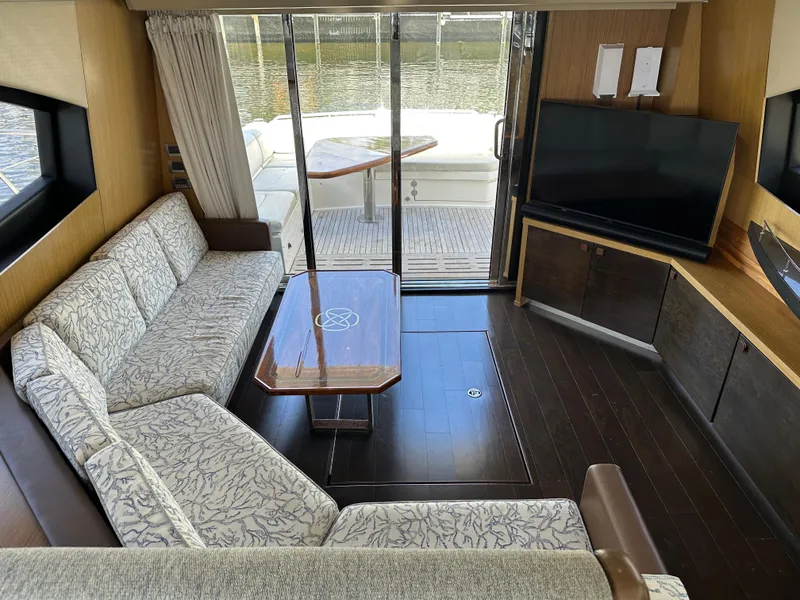 Slide: The Image of Luxurious interior of 2016 Sea Ray L590 yacht with elegant seating and large TV. - 33