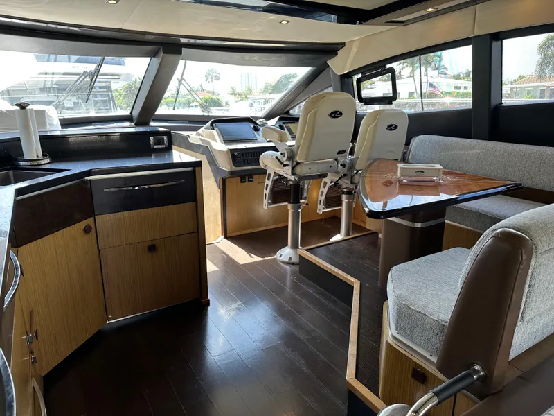 Slide: The Image of Luxurious 2016 Sea Ray L590 yacht interior with helm, seating, and modern kitchen area. - 37