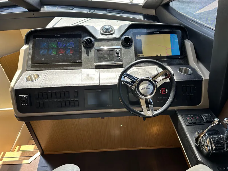 Slide: The Image of Helm of 2016 Sea Ray L590 yacht with modern navigation controls and steering wheel. - 38