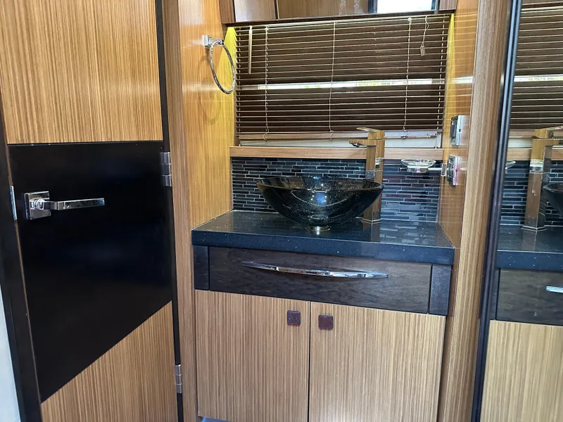 Slide: The Image of Luxurious bathroom interior of 2016 Sea Ray L590 yacht with modern sink and wood accents. - 44