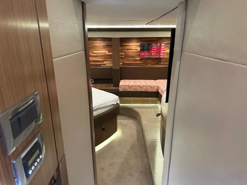 Slide: The Image of Luxurious interior of 2016 Sea Ray L590 yacht with modern wood paneling and cozy bedding. - 45