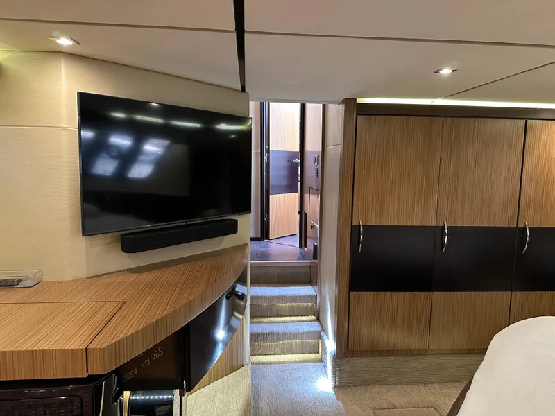 Slide: The Image of Luxurious interior of 2016 Sea Ray L590 yacht with modern TV and wooden cabinetry. - 47