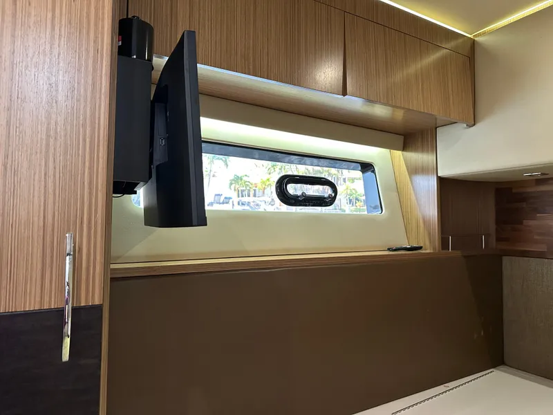 Slide: The Image of 2016 Sea Ray L590 interior with mounted TV and window view. - 5