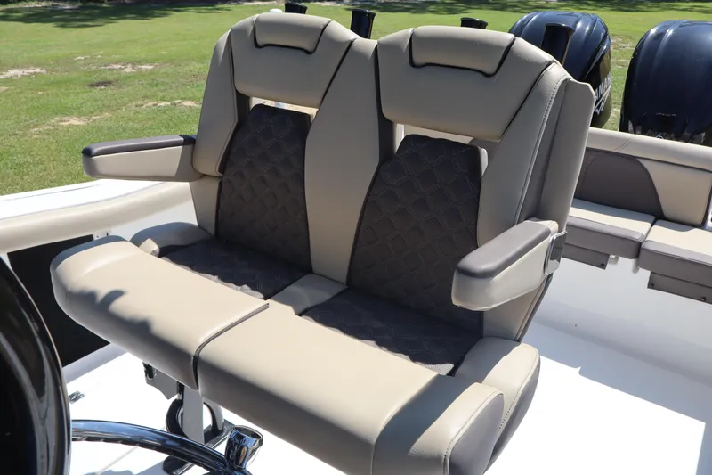 Slide: The Image of Luxury seating on 2022 Tidewater 272 LXF boat, featuring plush upholstery and armrests. - 14