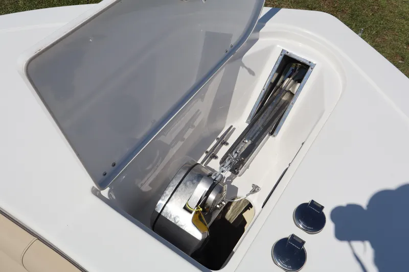 Slide: The Image of Open anchor compartment on 2022 Tidewater 272 LXF boat, showcasing anchor storage and mechanism. - 19