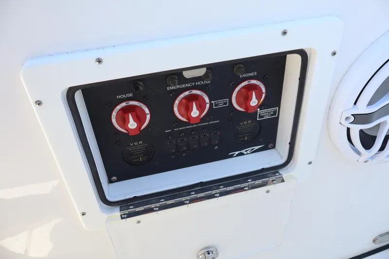 Slide: The Image of Control panel of 2022 Tidewater 272 LXF boat with red switches and speaker. - 25
