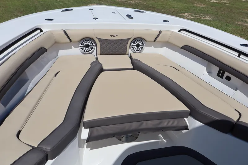 Slide: The Image of Luxurious seating area on 2022 Tidewater 272 LXF boat, featuring beige and black cushions. - 6