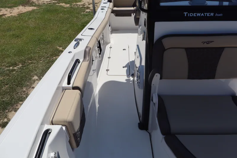 Slide: The Image of 2022 Tidewater 272 LXF boat interior with cushioned seating and sleek design. - 9