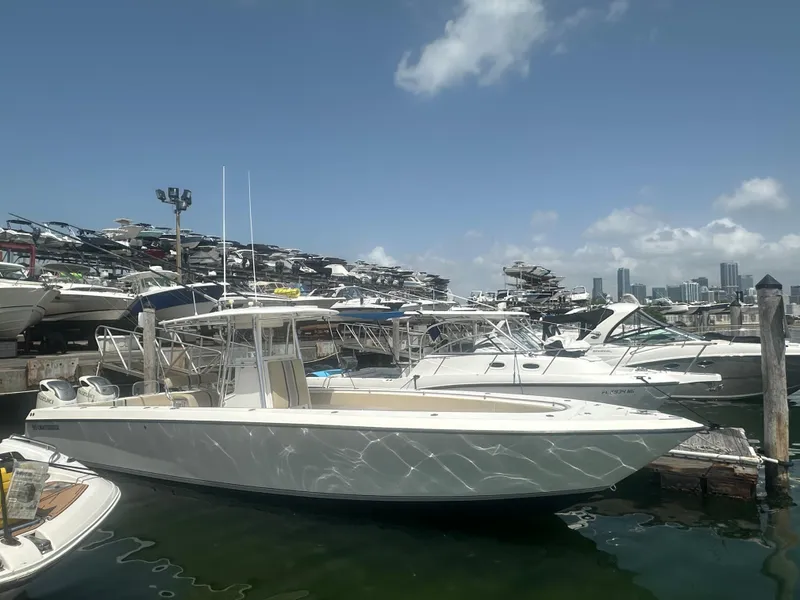 Slide: The Image of 2008 Contender 36 Open boat docked at a marina under a clear blue sky. - 10