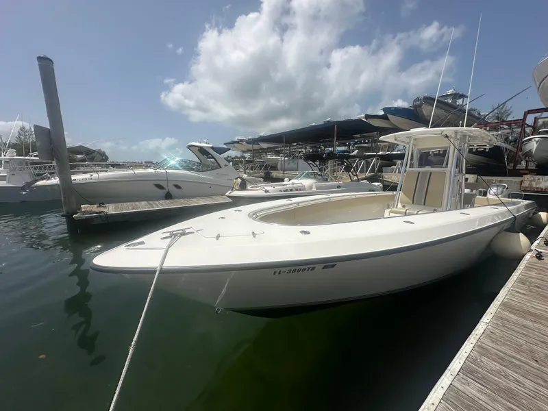 Slide: The Image of 2008 Contender 36 Open boat docked at marina under clear sky. - 11