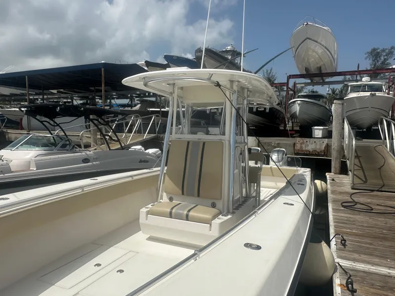 Slide: The Image of 2008 Contender 36 Open boat docked at marina under cloudy sky. - 13