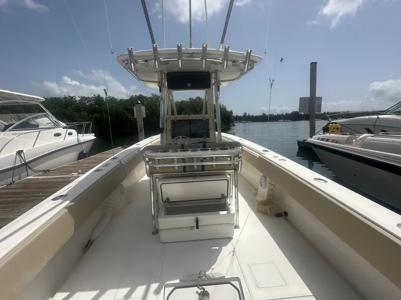 Slide: The Image of 2008 Contender 36 Open boat docked, featuring spacious deck and helm station. - 19