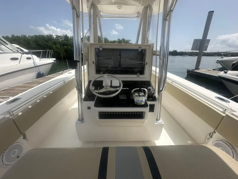 Slide: The Image of 2008 Contender 36 Open boat interior with steering console and seating, docked by the water. - 22