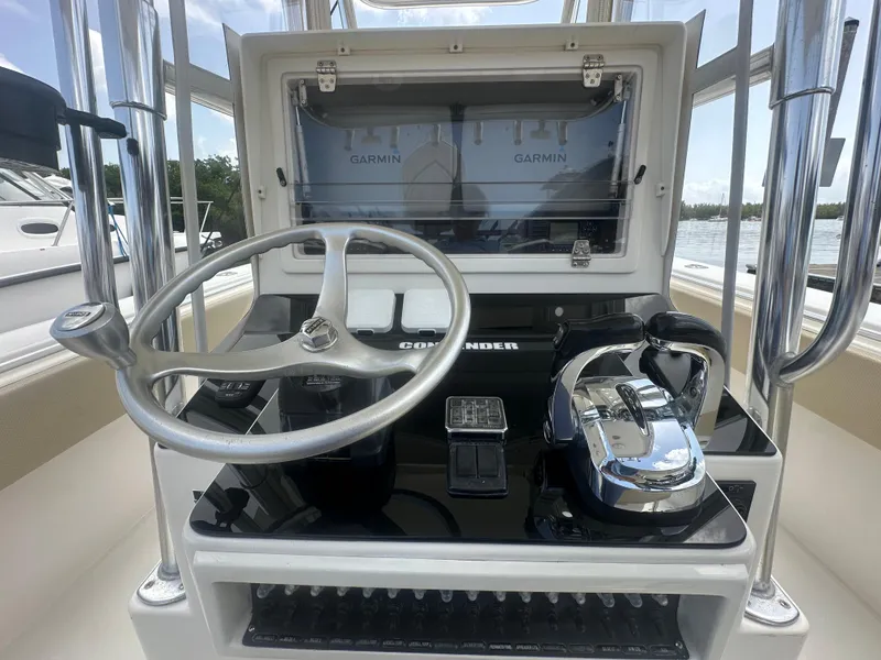 Slide: The Image of 2008 Contender 36 Open boat helm with Garmin displays and steering wheel. - 23