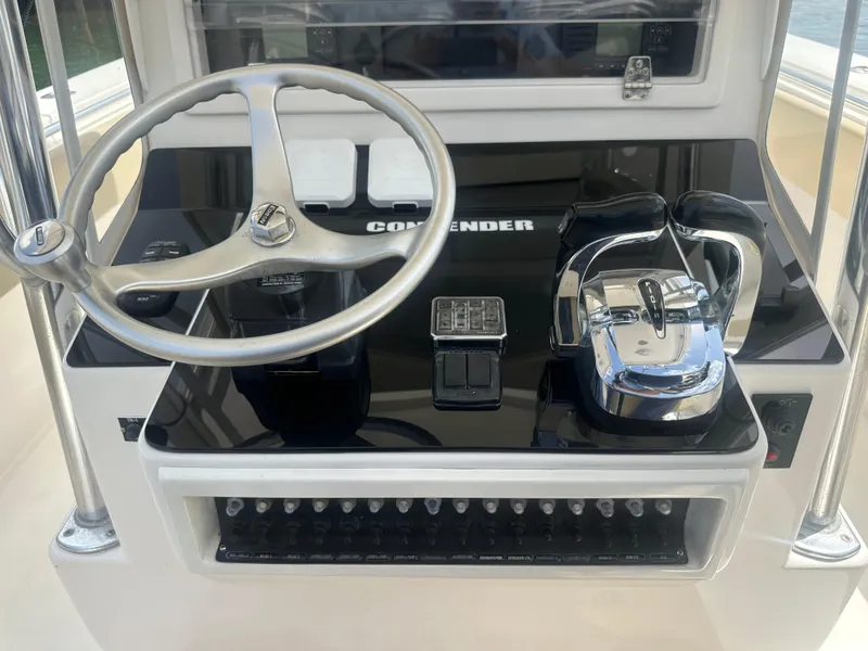 Slide: The Image of 2008 Contender 36 Open boat helm with steering wheel and controls. - 24