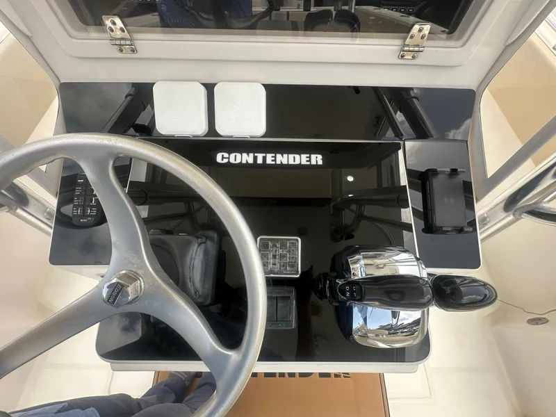 Slide: The Image of 2008 Contender 36 Open boat dashboard with steering wheel and controls. - 25