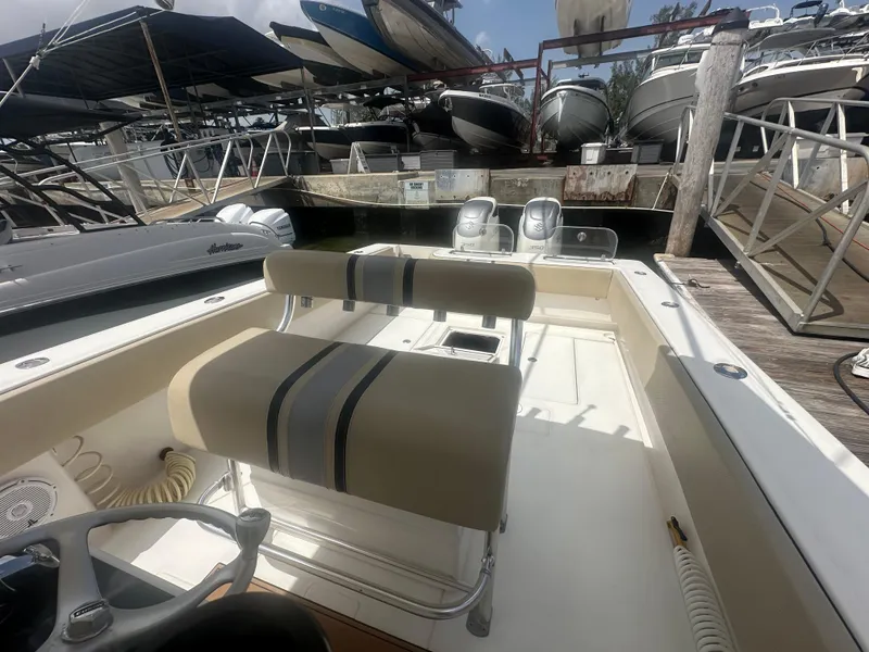Slide: The Image of 2008 Contender 36 Open boat interior with dual engines at a marina dock. - 27
