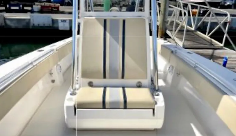 Slide: The Image of 2008 Contender 36 Open boat interior with striped seating at the dock. - 28