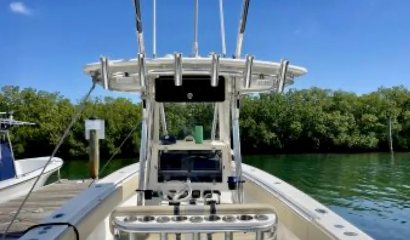 Slide: The Image of 2008 Contender 36 Open boat docked by lush green shoreline. - 29