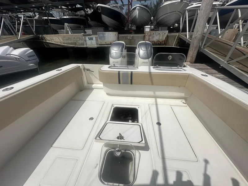 Slide: The Image of 2008 Contender 36 Open boat interior with seating and storage compartments at a marina. - 34