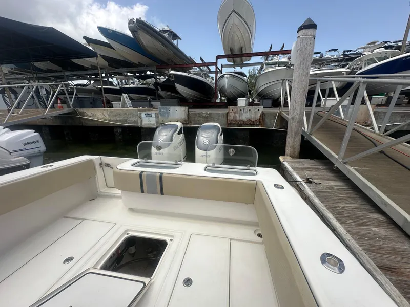 Slide: The Image of 2008 Contender 36 Open boat docked, featuring dual Suzuki engines, surrounded by other boats. - 45