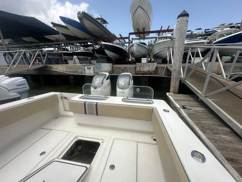 Slide: The Image of 2008 Contender 36 Open boat docked, surrounded by other boats in a marina. - 46