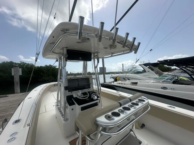 Slide: The Image of 2008 Contender 36 Open boat interior with helm, docked alongside other boats. - 48