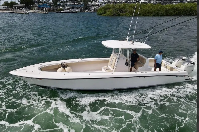Slide: The Image of 2008 Contender 36 Open boat cruising on water with two people onboard. - 5