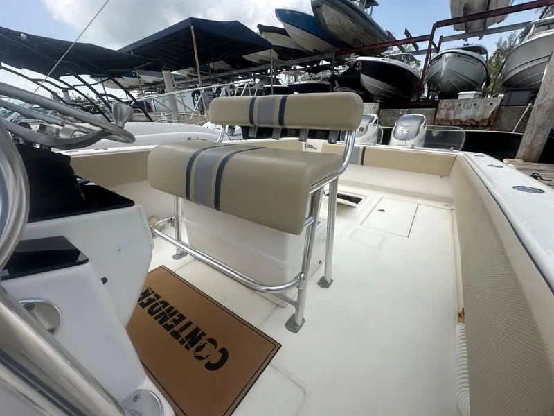 Slide: The Image of 2008 Contender 36 Open boat interior with seating and steering wheel, docked among other boats. - 50