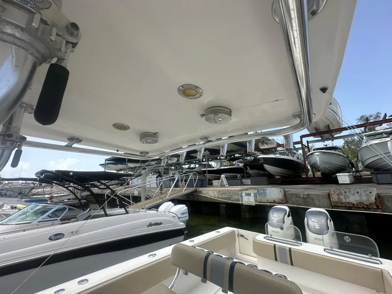 Slide: The Image of 2008 Contender 36 Open boat docked, surrounded by other vessels at a marina. - 51