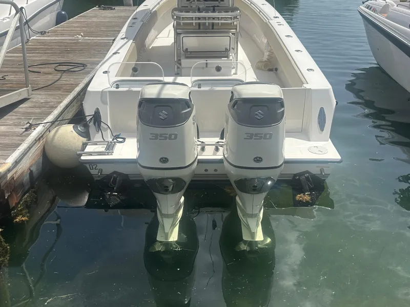 Slide: The Image of 2008 Contender 36 Open boat with twin Suzuki 350 outboard engines docked at marina. - 53