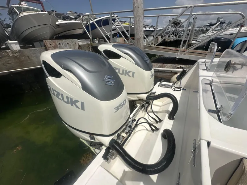 Slide: The Image of 2008 Contender 36 Open boat with twin Suzuki 350 outboard engines at dock. - 54