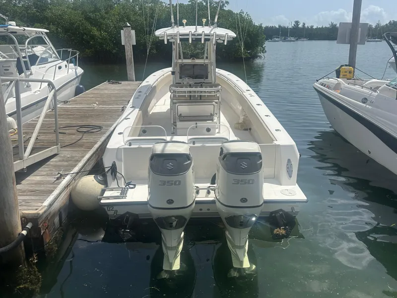 Slide: The Image of 2008 Contender 36 Open boat docked with dual Suzuki 350 engines. - 55