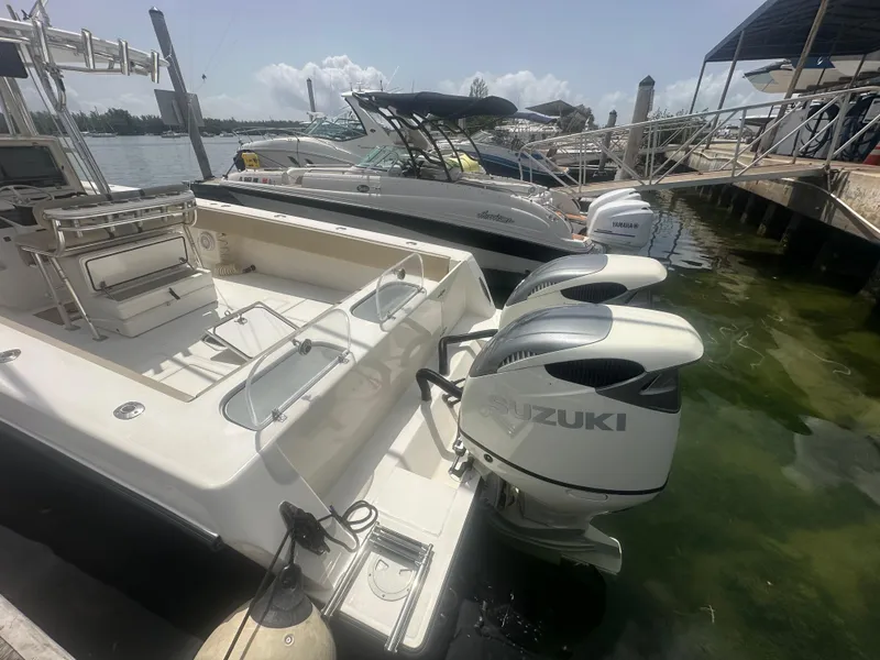 Slide: The Image of 2008 Contender 36 Open boat with Suzuki outboard engines docked at marina. - 56