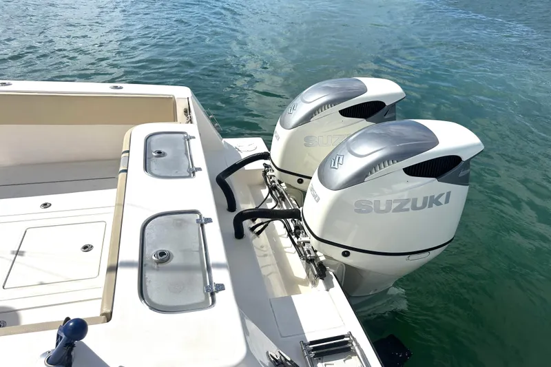 Slide: The Image of 2008 Contender 36 Open boat with dual Suzuki outboard motors on water. - 67