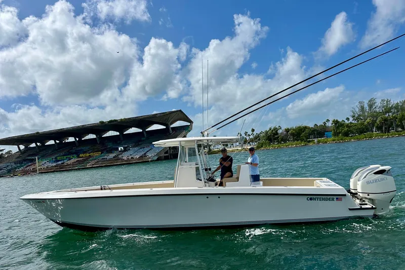 Slide: The Image of 2008 Contender 36 Open boat cruising near a stadium, under a partly cloudy sky. - 70