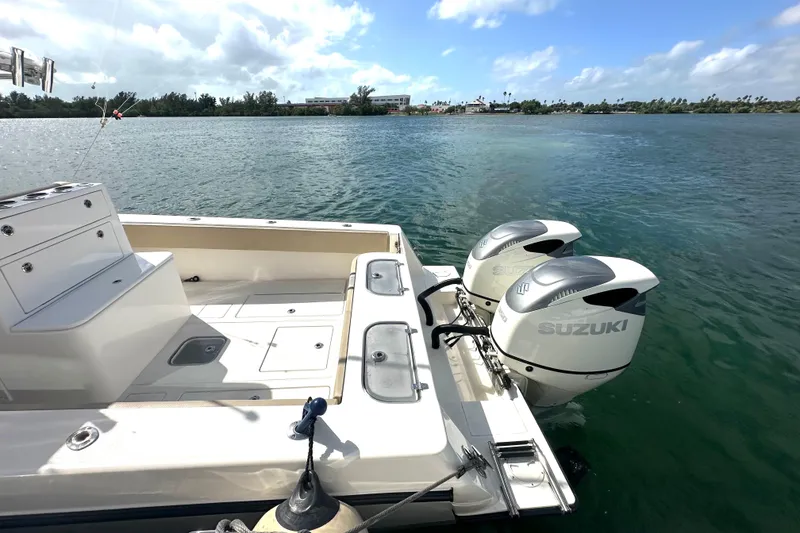 Slide: The Image of 2008 Contender 36 Open boat with dual Suzuki outboard motors on a sunny day. - 73