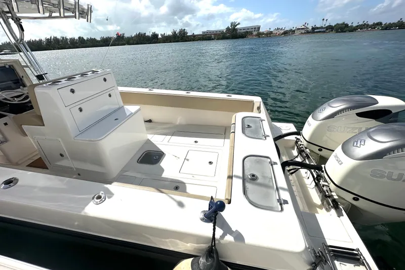 Slide: The Image of 2008 Contender 36 Open boat with dual Suzuki engines, docked on a sunny day. - 74