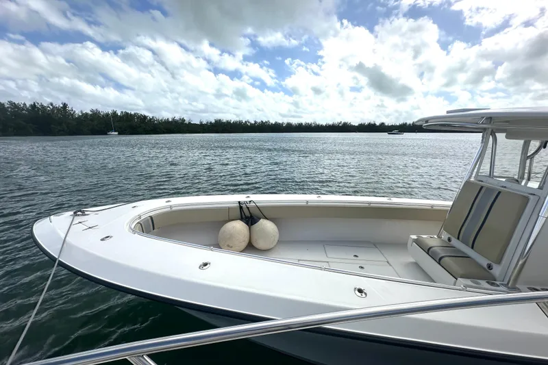 Slide: The Image of 2008 Contender 36 Open boat on calm water under a cloudy sky. - 76