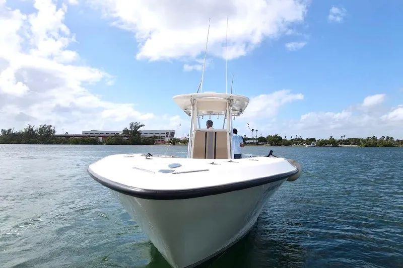 Slide: The Image of 2008 Contender 36 Open boat on water, clear sky, and distant shoreline. - 77
